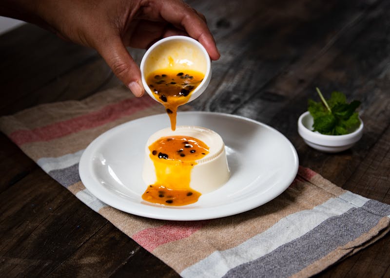 Silky vanilla panna cotta with berry coulis