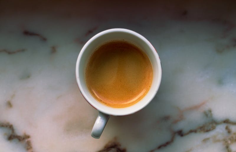 Rich Italian espresso with crema in a small ceramic cup