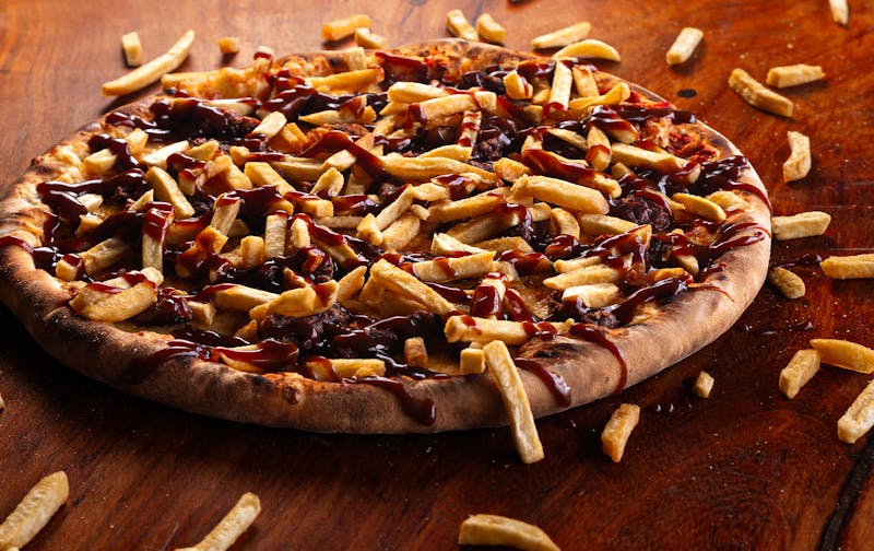 BBQ chicken pizza with smoky sauce and caramelized onions